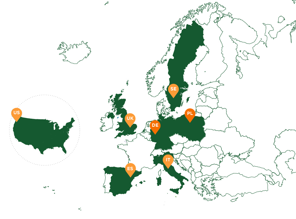Older woman standing on a rock looking out over the ocean